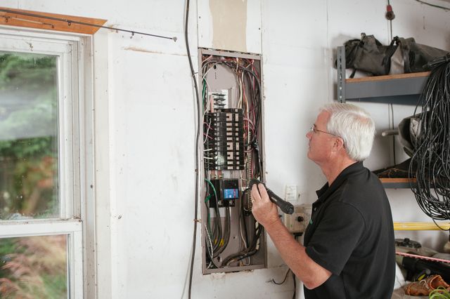 person inspecting household electrical